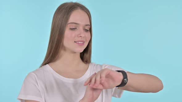 Beautiful Young Woman Using Smartwatch, Blue Background