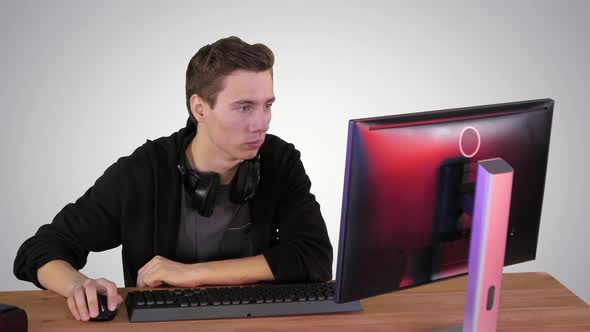 Young Man Gamer Watching Stream Game on Gradient Background.