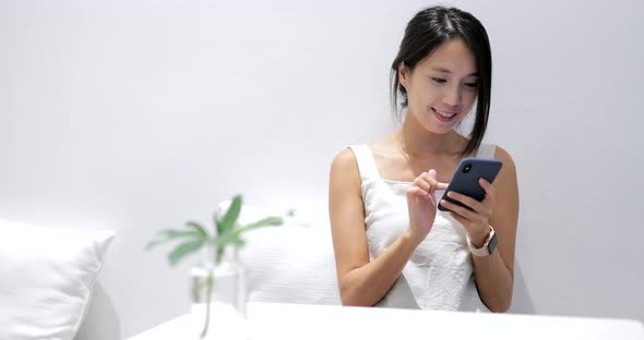 Woman use of mobile phone in restaurant 