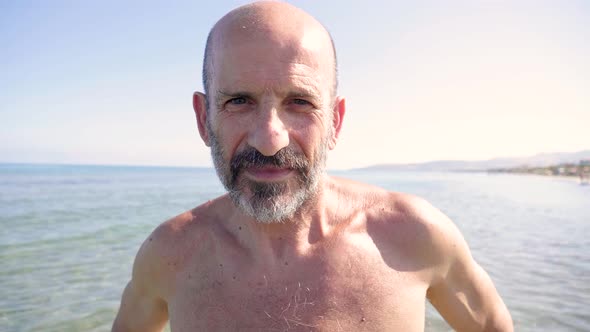 Slow motion shot of senior man at beach