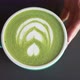 Female Hands Put Cup of Green Matcha with Latte Art on Table - VideoHive Item for Sale