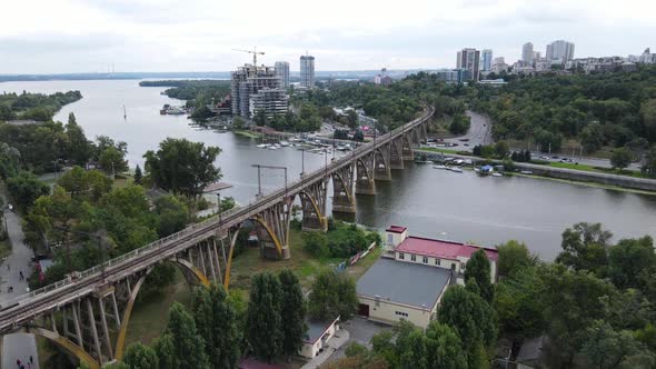 Europe's Unique Arched Railway Bridge Over the Dnieper River with a Lively Embankment and Yacht Club