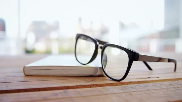 Close-up of spectacles on book