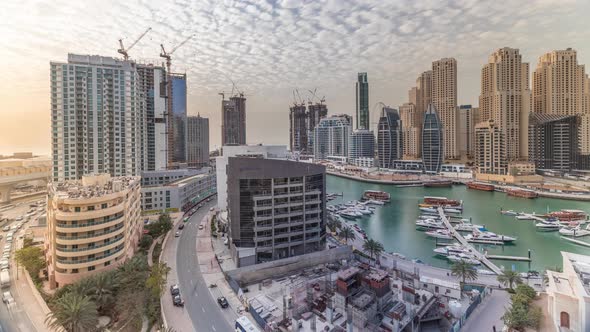 Yachts in Dubai Marina Flanked By the Al Rahim Mosque and Residential Towers and Skyscrapers Aerial