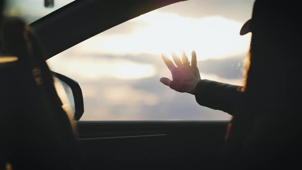 Female Hands of a Car While Driving
