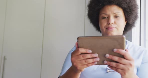 Video of focusedplus size african american female doctor using tablet