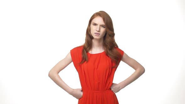 Angry Annoyed Woman in Gorgeous Orange Dress Hand on Wrist Isolated Over White Background.