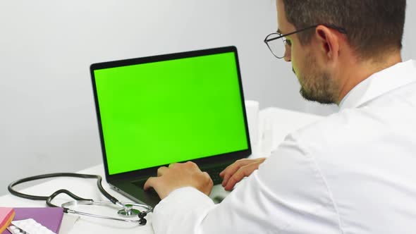 Doctor Scrolling Chroma Key Laptop at Medical Cabinet