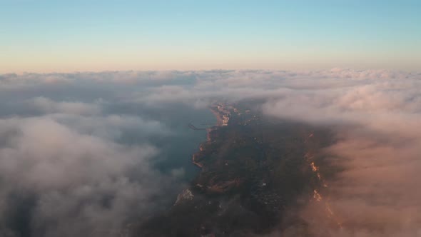 Aerial video over low clouds and morning fog alt