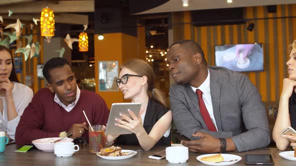 Multi-ethnic Friends Laughing Having Fun at Meeting in Coffeehouse.