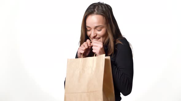 Cheerful Young Woman Holding Shopping Bag