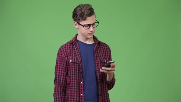 Young Handsome Teenage Nerd Boy Using Phone