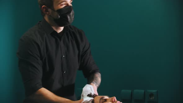 Man Barber with Tattoes Drying Out His Client Hair