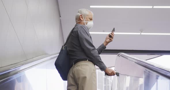 Caucasian man out and about in a metro station wearing on a face mask against coronavirus