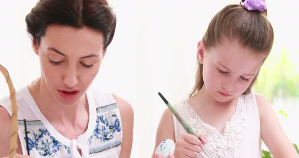 Mother and Daughter Painting Easter Eggs