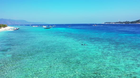 Luxury fly over abstract shot of a white sand paradise beach and aqua blue water background in color