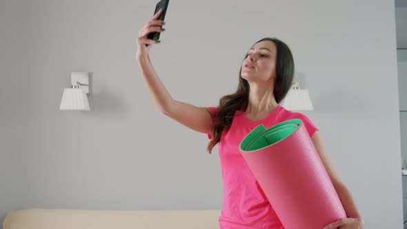 Cheerful Young Woman Holds Yoga Mat Her Hand Talks Phone