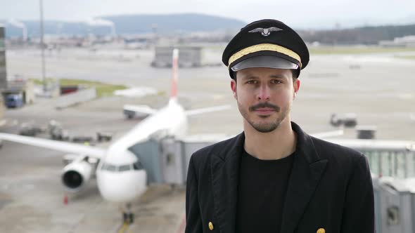 Portrait of Young Professional Male Pilot in Uniform