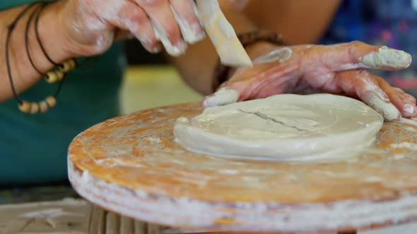 Mid section of man carving clay 4k