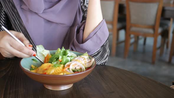 Women Eating Grilled Chicken With Mango Salsa in a Bowl