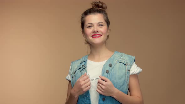 Caucasian Woman in Studio on Beuge Background Have Fun and Poses To Camera