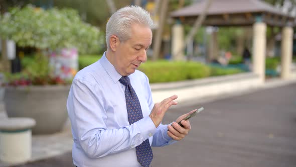 Businessman Swiping Up On A Smartphone