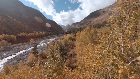 Stormy River Flowing in Mountain Valley. Aerial Cinematic View From Sport Fpv Drone Flight Between