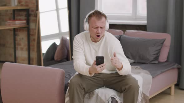 Energetic Man in Headphones Moving to Music