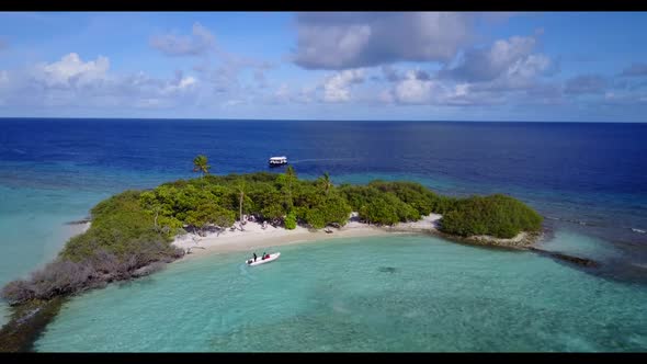 Aerial drone shot seascape of perfect island beach lifestyle by blue lagoon and white sandy backgrou