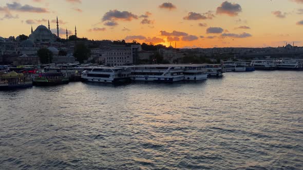 Slow Tilt Up Revealing Golden Horn Bosphorus and Istanbul Cityscape in Beautiful Sunsets with Mosque