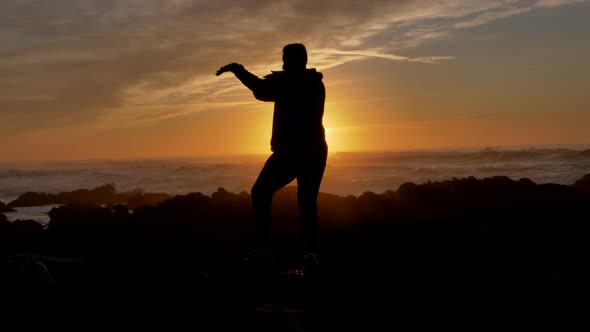 Men Warrior Monk Practicing Silhouette Tai Chi Karate Kung Fu on the Rocky Stones Horizon at Sunset