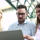 Three Young Smiling Colleagues Working Together on Laptop - VideoHive Item for Sale