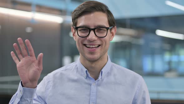 Portrait of Young Man Waving Hand Welcoming