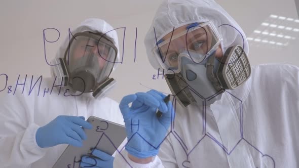 Two Doctors in Medical Suits Are Investigating the Covid-19 Virus in the Lab.
