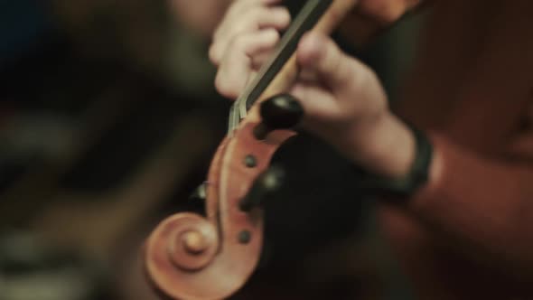 Close View of Female Violinist Rehearsing the Instrumental Melody with Violin