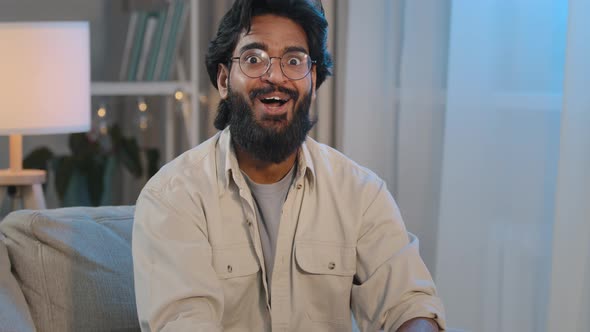 Arabic Bearded Surprised Indian Shocked Man in Glasses at Home Looking at Camera Says Wow Wide Opens