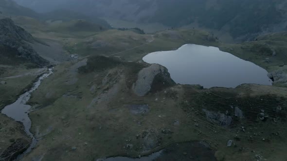 Aerial Bird's Eye View of Narrow Steams Bringing Water From the Glaciers to the Lake Ayous at Sunset