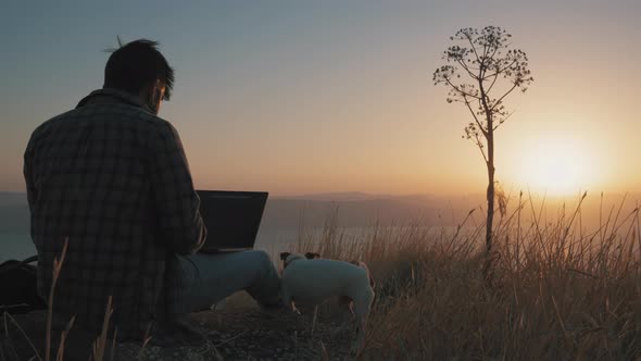 Back view of a man working outdoors