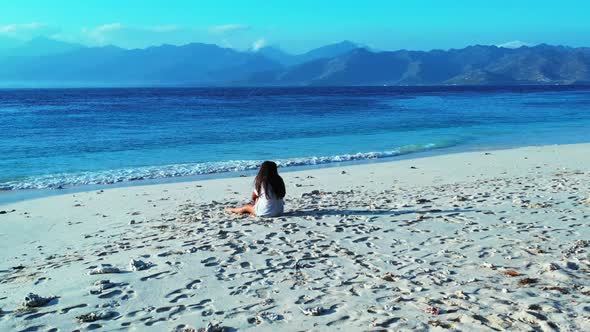 Beautiful women posing on tropical sea view beach lifestyle by turquoise ocean with white sandy back