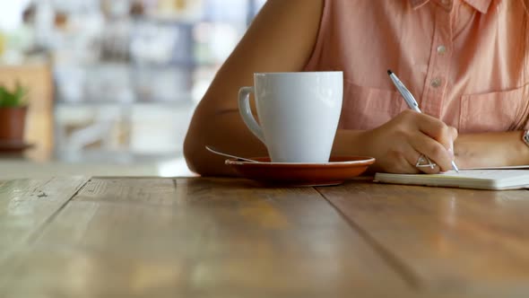 Teenage girl writing on a diary