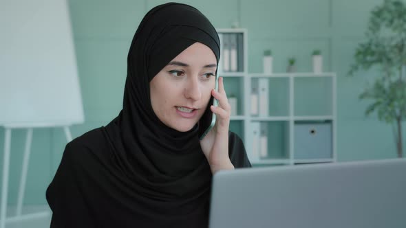 Angry Islamic Muslim Arabic Woman Working with Laptop Shout Scream Speaking on Mobile Phone in