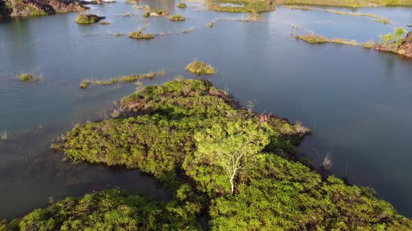 Aerial ascending and look down mining lake