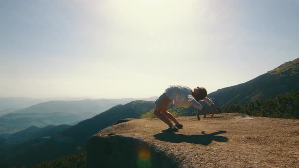 Girl Doing Yoga in the Mountains at Sunrise