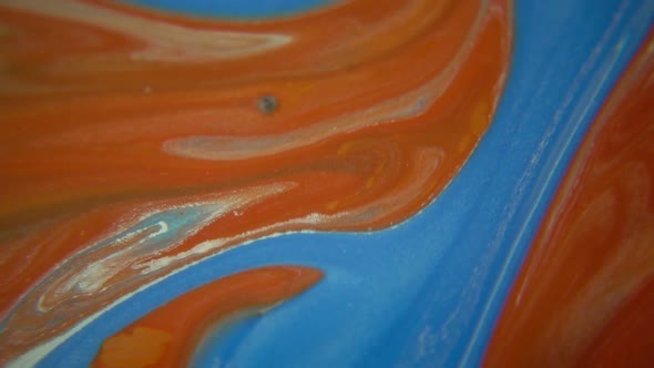 Blue Paint Poured Into Red Paint alt