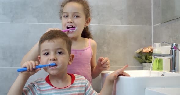 Portrait Happy Cute Young Children Brushing Teeth in Bathroom and Smiling