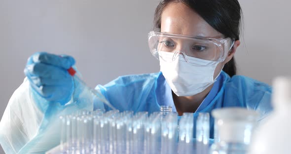 Female doctor analyzing liquid in test tube