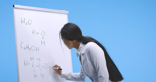 Young Scientist Writing Chemical Formulas