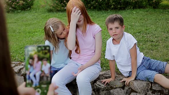 Happy Family are Photographed on the Phone in the Park