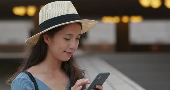 Woman use of mobile phone in city