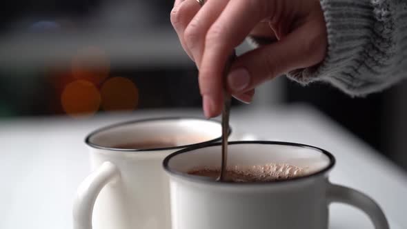 Woman Stirring Cacao in White Mug